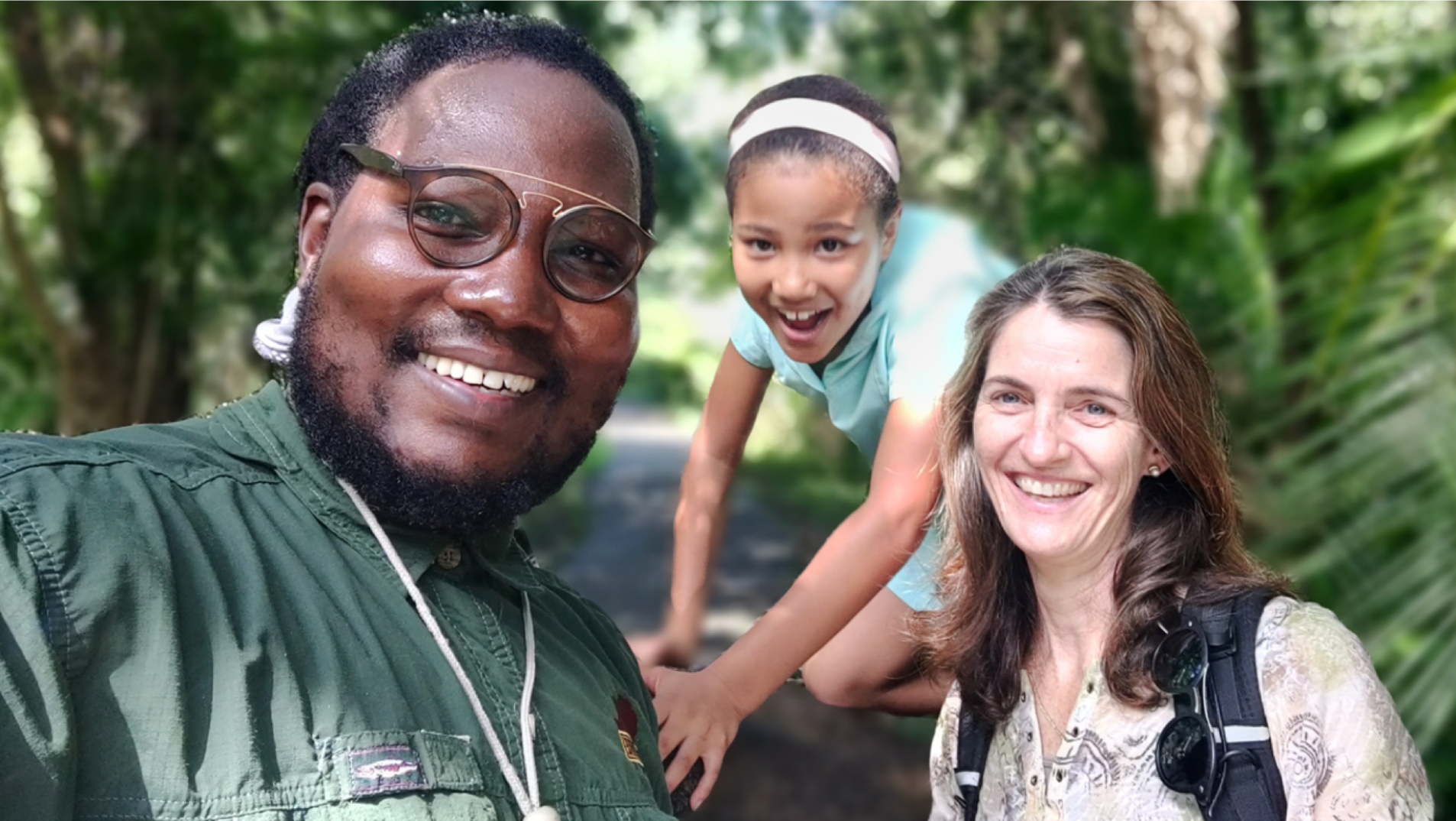 photo of couple and young girl smiling at camera behind greenery