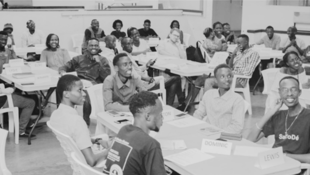 black and white photo of young students sitting at tables