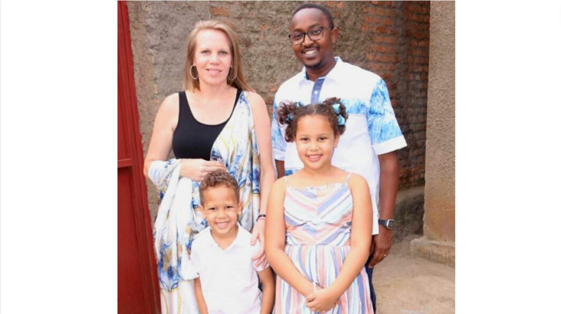 photo of couple and two young children smiling at camera