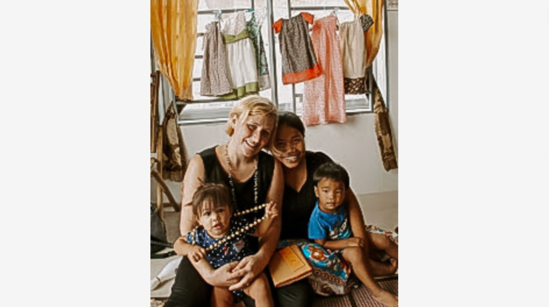 photo of two ladies and two small children behind a window